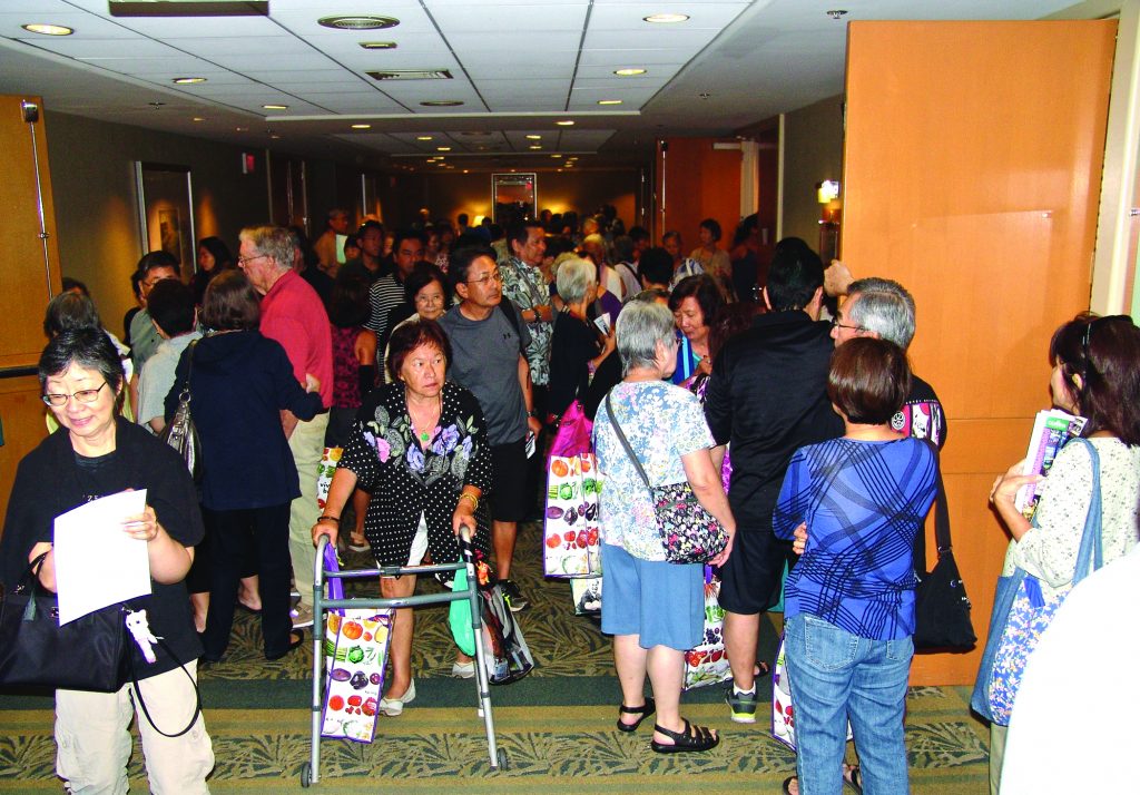 (Above) In between sessions, attendees filled the hallways of the Ala Moana Hotel. More than 3,000 people were at this year’s event. (Below, left) A well-attended session this year was, “Improving Life At Home For Caregivers & Elders” by Dr. Michael Cheang, an assistant professor at the University of Hawai‘i at Ma¯noa Center on Aging. 