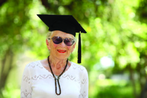 Happy senior woman in graduate cap