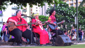 a hawaiian band performs for a hula show at waikiki