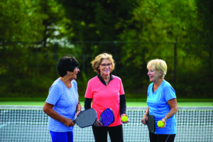 Senior women at a tennis court. Active seniors living a healthy lifestyle. Staying active in retirement.