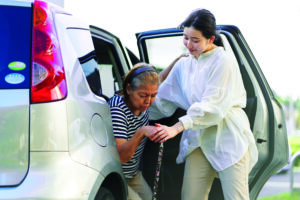 A woman who removes an elderly person from a car