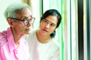 Younger woman talking with senior person about long-term care